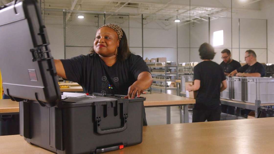 Expo Pass employee packing an on-site event badge printing kit to send to conference.
