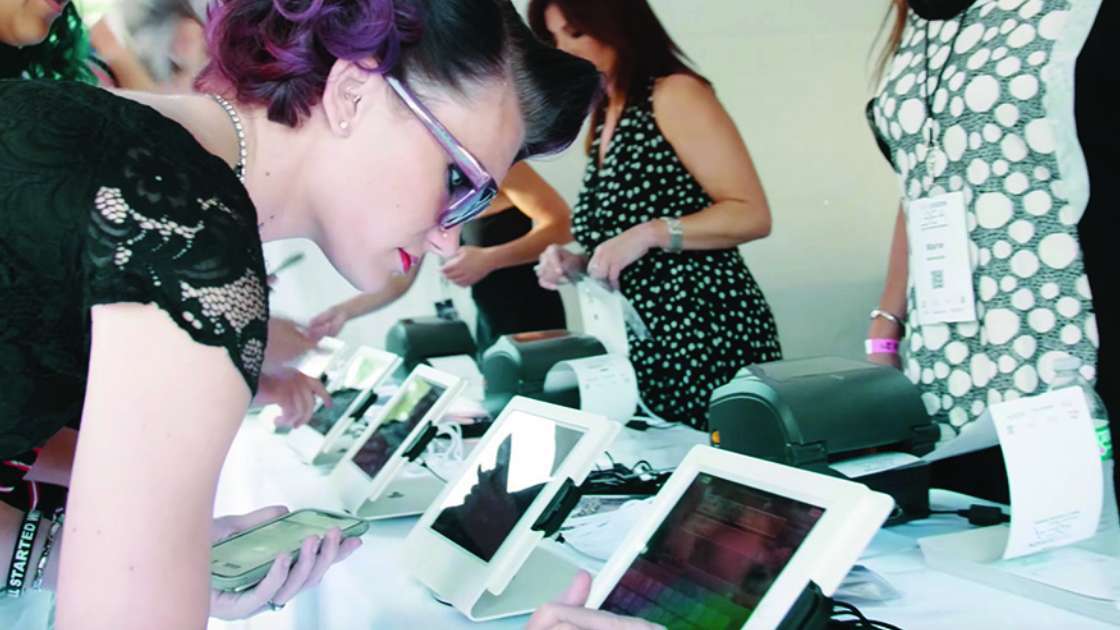 Event attendee checking into an event on a Expo Pass check-in kiosk. 