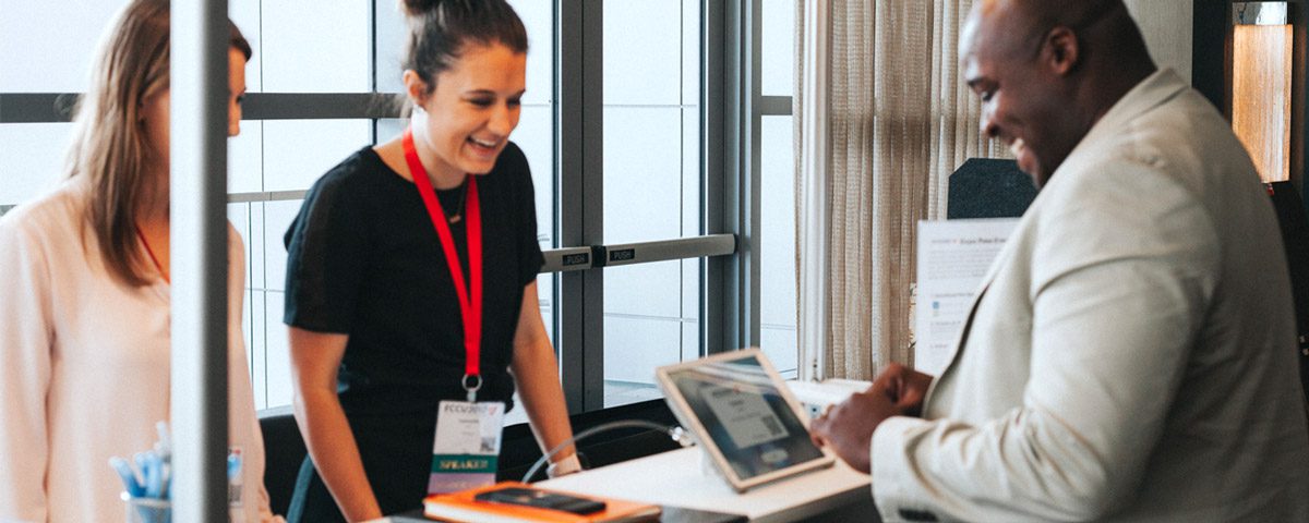 Attendee checks in at an on-site badge printing kiosk