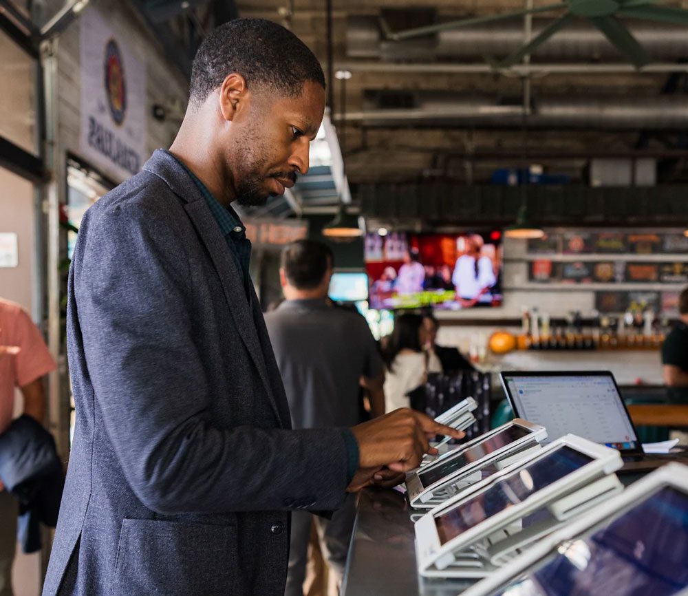 Attendee checking in at onsite conference badge printing iPad kiosk